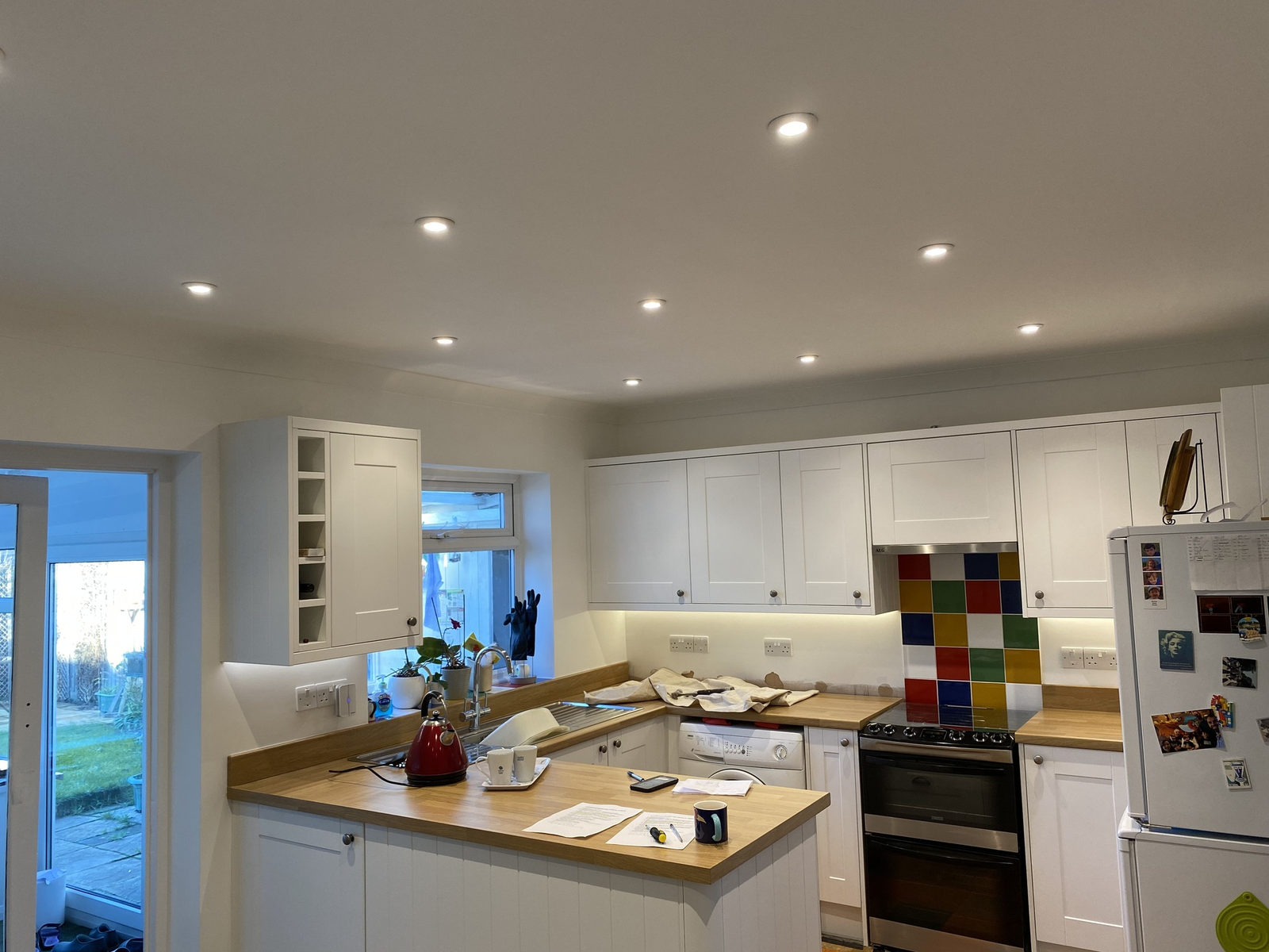 A kitchen lit with recessed LED downlights and under-cupboard lighting by Ferrie Electrical